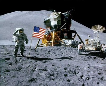 Astronaut Jim Irvin with the Apollo 15 lunar module and rover in front of Mons Hadley